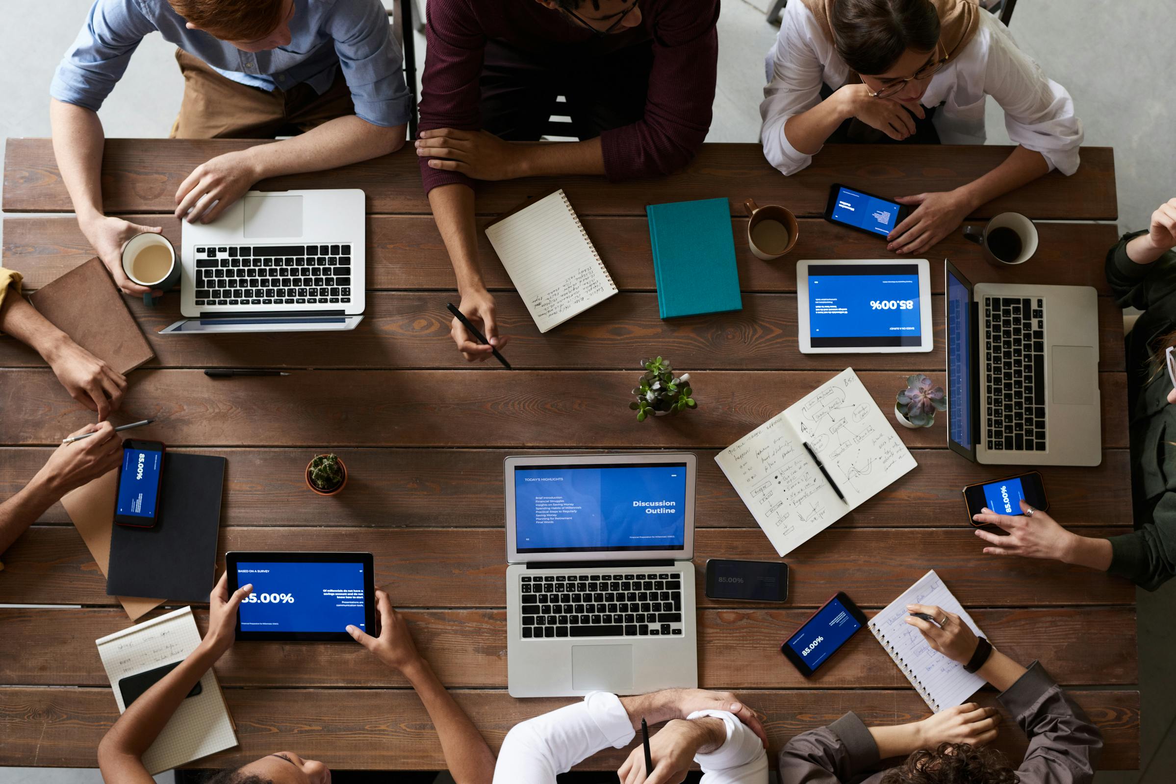 A small group of people collaborating on laptops, representing a tight-knit online community before the rules take over