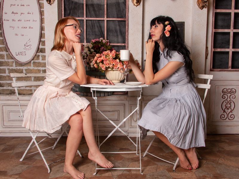Two women having an intimate conversation over coffee at a cafe