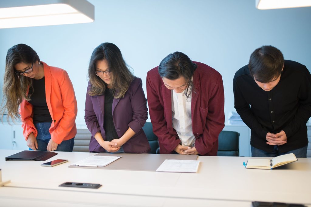 Group of people bowing in greeting