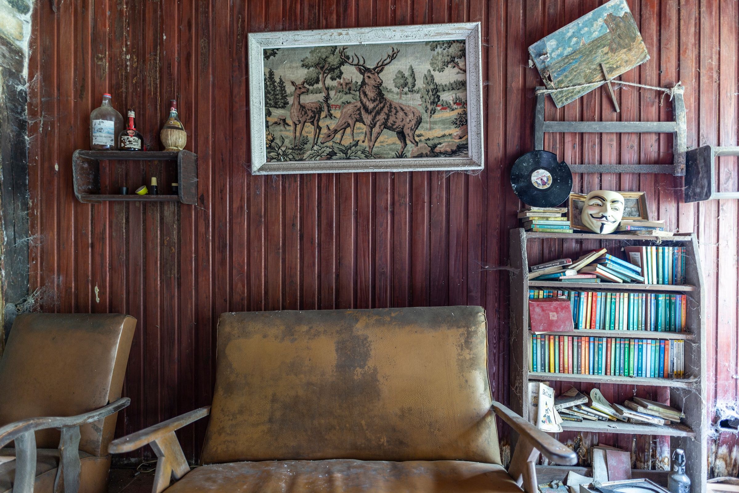 The House Can't Be Split: On Inheritance and the Ethics of Who Gets What 4 A vintage room with a worn armchair and shelves of old belongings