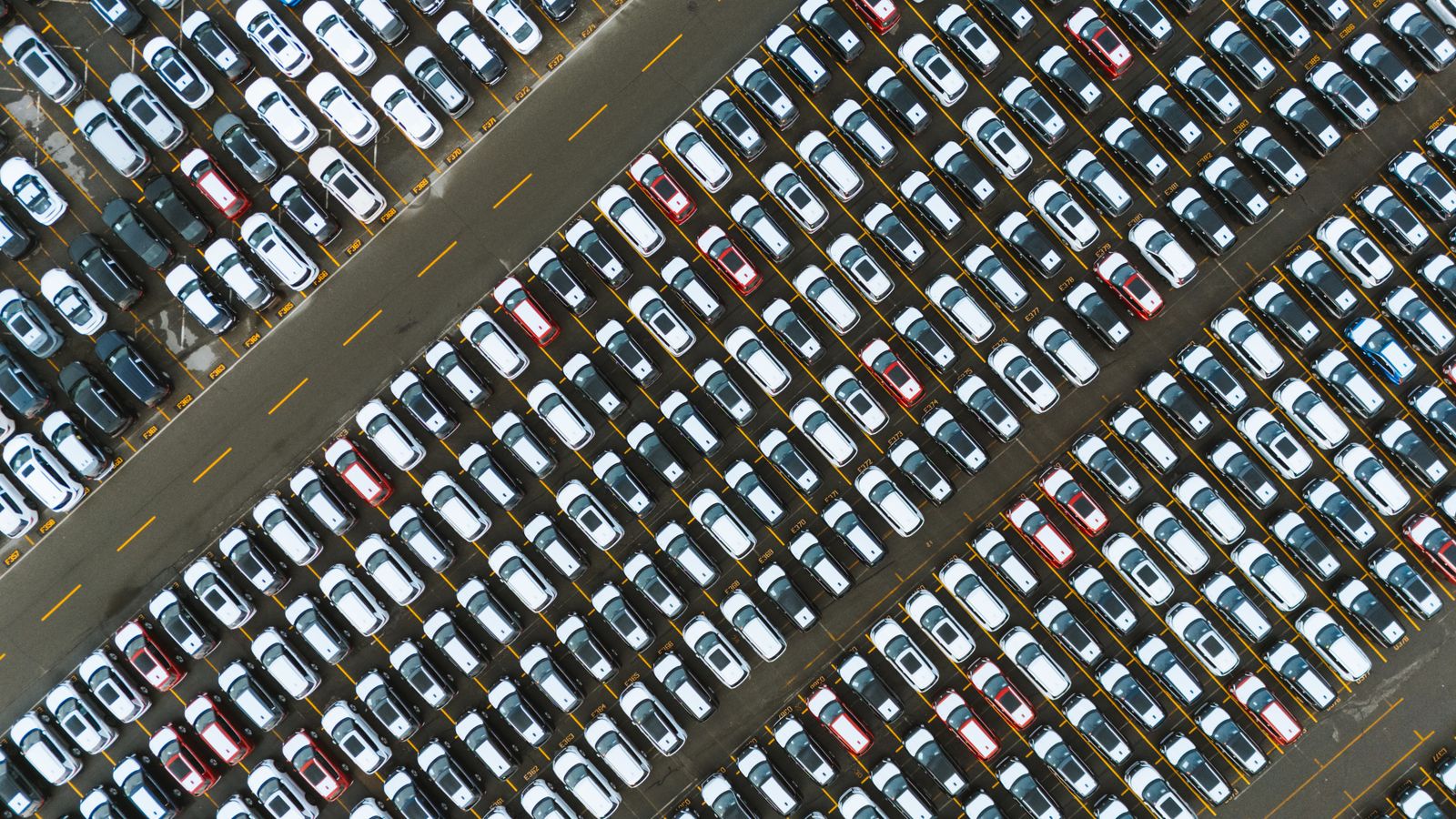 Aerial view of a crowded parking lot filled with parked cars
